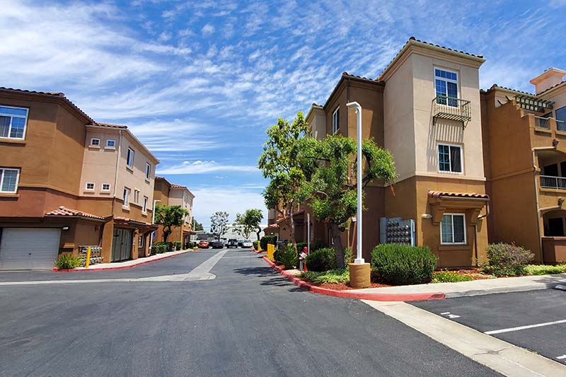 Entry to community with view of buildings and trees